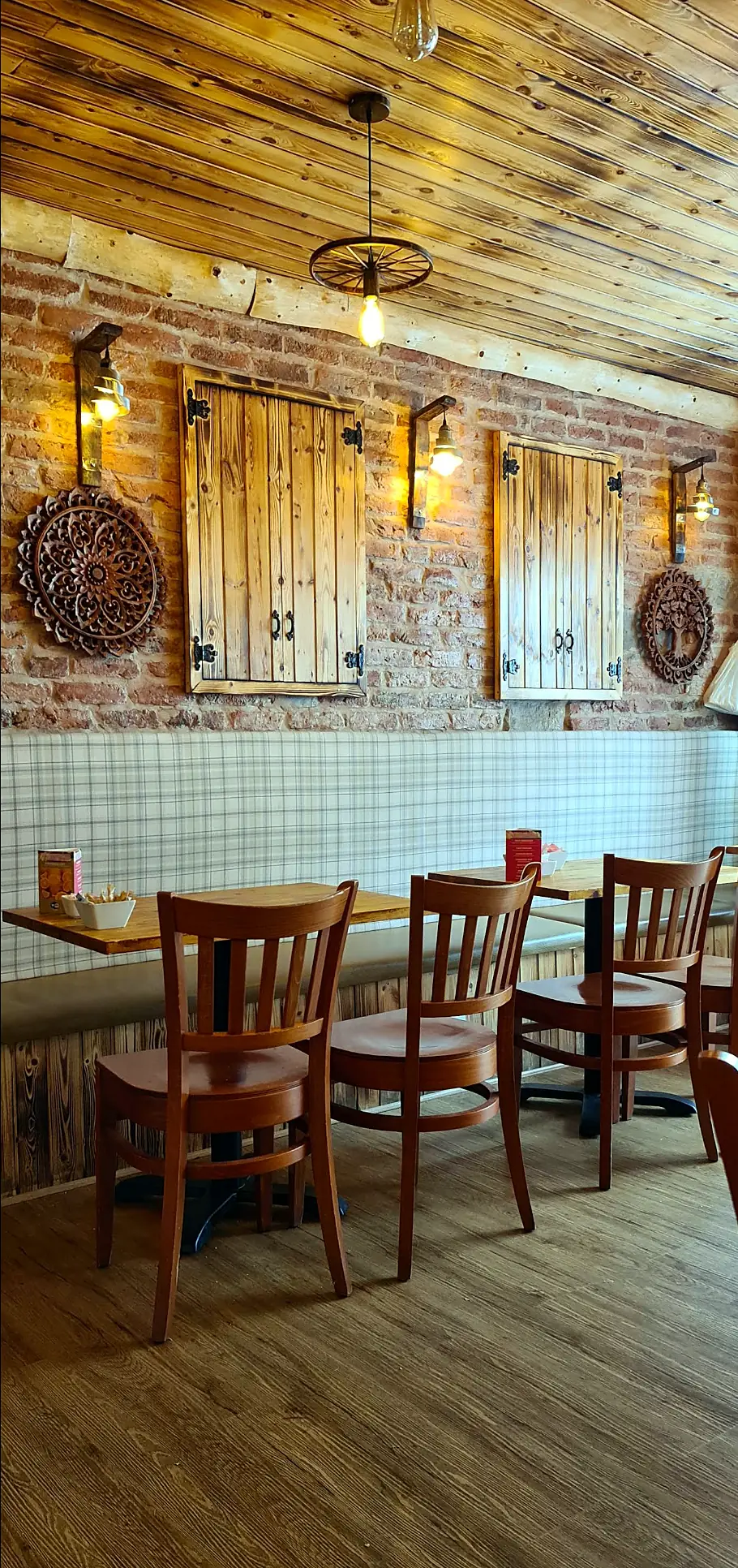 Tartan banquette beneath rustic wooden shutters