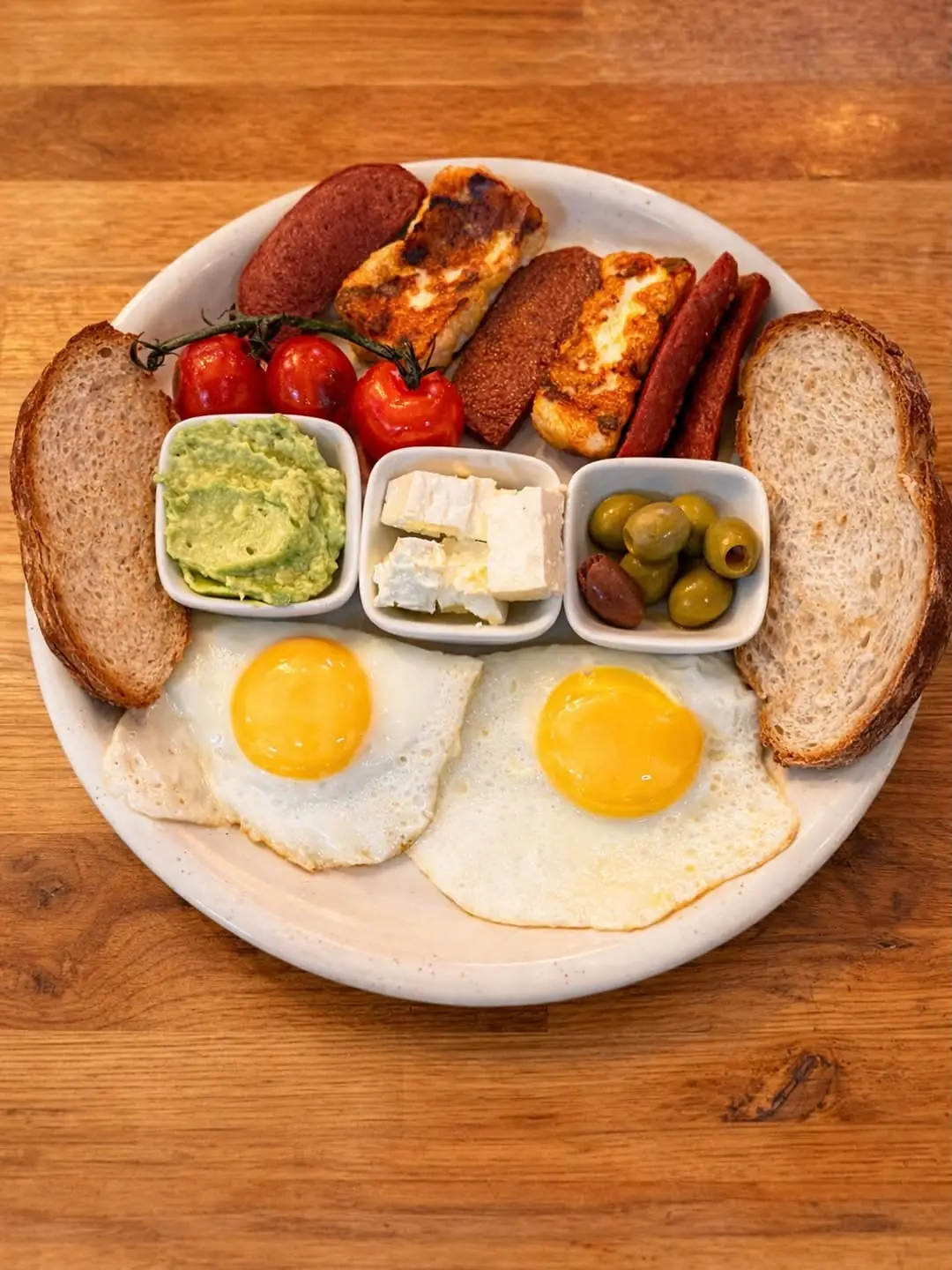 Mediterranean breakfast with eggs, halloumi, spicy sausage, feta, olives and avocado